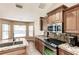 Cozy kitchen with granite counters, stainless steel appliances, and a charming breakfast nook at 4238 Golfair Ln, North Port, FL 34288