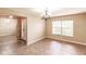 A sunny living room has tile flooring and neutral paint tones at 4238 Golfair Ln, North Port, FL 34288