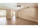 The living room has tile flooring, neutral paint tones, and a ceiling fan at 4238 Golfair Ln, North Port, FL 34288