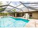 Enclosed pool area with a screened-in enclosure and jacuzzi, offering a private outdoor retreat at 4238 Golfair Ln, North Port, FL 34288