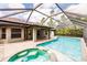 Screened-in pool with attached jacuzzi tub and covered patio at 4238 Golfair Ln, North Port, FL 34288