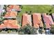 A neighborhood aerial view features homes with terracotta roofs, lush landscaping, and well-maintained lawns at 4308 Summertree Rd, Venice, FL 34293
