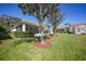 Green backyard featuring well-maintained landscaping and serene privacy at 4308 Summertree Rd, Venice, FL 34293