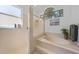 Bright bathroom featuring a soaking tub with tile surround and separate shower with glass enclosure at 4308 Summertree Rd, Venice, FL 34293