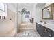 Serene bathroom with a soaking tub, tiled shower, double vanity, and contemporary finishes for a spa-like experience at 4308 Summertree Rd, Venice, FL 34293