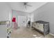 Neutral Bedroom featuring a rocking chair, modern crib, and ample closet space at 4308 Summertree Rd, Venice, FL 34293