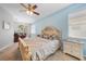 Tranquil bedroom featuring a comfortable bed, soft blue walls, and a sliding glass door leading to a screened patio at 4308 Summertree Rd, Venice, FL 34293