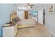 Bright bedroom featuring a cozy bed, neutral decor, and ample natural light with an adjacent sliding barn door at 4308 Summertree Rd, Venice, FL 34293