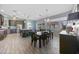 Modern kitchen with an island and breakfast bar, stainless appliances, and tile flooring that opens to dining area at 4308 Summertree Rd, Venice, FL 34293