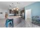 Spacious kitchen with dark wood cabinets, stainless steel appliances, a center island, and tile flooring at 4308 Summertree Rd, Venice, FL 34293