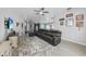Inviting living room featuring a comfortable leather sectional sofa, neutral decor, and an open layout to the kitchen at 4308 Summertree Rd, Venice, FL 34293