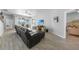 Relaxing living room with a large leather sofa, a flat-screen TV, and access to the outdoor patio through sliding glass doors at 4308 Summertree Rd, Venice, FL 34293
