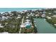 Aerial view of the home's location, surrounded by water, palm trees, and other houses at 50 Tarpon Way, Placida, FL 33946