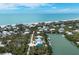 Coastal aerial view of waterfront homes surrounded by lush greenery and sandy beaches at 50 Tarpon Way, Placida, FL 33946