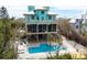 Gorgeous backyard with a swimming pool, spa, and a patio with a kayak underneath the home at 50 Tarpon Way, Placida, FL 33946
