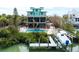 Beautiful backyard with a dock, lift, swimming pool, and lots of space for outdoor activities at 50 Tarpon Way, Placida, FL 33946