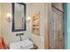 Stylized bathroom with vessel sink, vintage faucet, and wooden cabinet at 50 Tarpon Way, Placida, FL 33946
