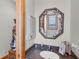 A cozy bathroom showcasing a unique seashell-framed mirror above the sink at 50 Tarpon Way, Placida, FL 33946