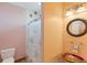 Pink bathroom featuring decorative glass sink, toilet and shower with decorative shower curtain at 50 Tarpon Way, Placida, FL 33946