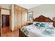 Bright bedroom with a floral-patterned bedspread and natural wood closet doors at 50 Tarpon Way, Placida, FL 33946