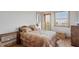 Cozy bedroom with natural light, light wood floors, and balcony access at 50 Tarpon Way, Placida, FL 33946