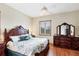 Comfortable bedroom features a large bed, dresser with mirror, and natural light at 50 Tarpon Way, Placida, FL 33946