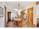 Charming dining area with wood table, chairs, chandelier, and staircase access at 50 Tarpon Way, Placida, FL 33946