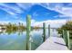 The property has a private dock with a beautiful waterfront view on a clear, sunny day at 50 Tarpon Way, Placida, FL 33946