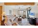 A cozy living room with tile flooring and exposed wood beams, providing a warm and inviting space at 50 Tarpon Way, Placida, FL 33946