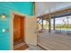 Open porch with elevator access, wood decking, and pool views, ideal for relaxing and entertaining at 50 Tarpon Way, Placida, FL 33946