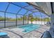 Backyard pool with integrated jacuzzi is enclosed by a screened-in patio at 6337 Shaw St, Englewood, FL 34224