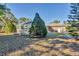 Expansive backyard featuring a screened pool enclosure and mature trees at 6345 Bodmin Ln, North Port, FL 34291