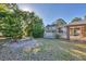 Landscaped backyard with a screened-in pool area and lush greenery at 6345 Bodmin Ln, North Port, FL 34291