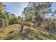 Fenced backyard featuring a lovely tree and a secure perimeter at 6345 Bodmin Ln, North Port, FL 34291