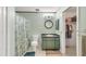 Bathroom with a shower/tub combination, a round mirror above the sink and a walk in closet at 6345 Bodmin Ln, North Port, FL 34291