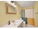 Bathroom with a shower/tub combination, a decorative mirror above the sink and tile flooring at 6345 Bodmin Ln, North Port, FL 34291