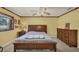 Bedroom featuring wood trim, ceiling fan, neutral walls, and a large window for natural light at 6345 Bodmin Ln, North Port, FL 34291