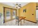 Bright dining area with tile floors, ceiling fan and access to the backyard through glass paneled doors at 6345 Bodmin Ln, North Port, FL 34291