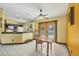 Open concept kitchen with breakfast bar, adjacent to the dining area with backyard access at 6345 Bodmin Ln, North Port, FL 34291