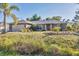 Charming single-story home with a well-maintained lawn and mature landscaping at 6345 Bodmin Ln, North Port, FL 34291