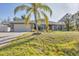 Charming single-story home with a well-maintained lawn and a palm tree in the front yard at 6345 Bodmin Ln, North Port, FL 34291