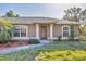 Inviting front entrance with a decorative glass door and well-manicured landscaping at 6345 Bodmin Ln, North Port, FL 34291