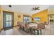 Cozy living room featuring tile floors, ample seating, and a decorative ceiling fan at 6345 Bodmin Ln, North Port, FL 34291