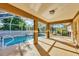 Screened pool with attached covered patio offers shade and outdoor living space at 6345 Bodmin Ln, North Port, FL 34291