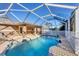 Relax in this sparkling pool surrounded by a screened enclosure and sunny skies at 6345 Bodmin Ln, North Port, FL 34291