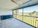 Spacious screened balcony featuring a view of a pond and lush greenery at 6800 Placida Rd # 272, Englewood, FL 34224