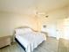 Cozy bedroom featuring a wicker bed frame, ceiling fan, and neutral color palette at 6800 Placida Rd # 272, Englewood, FL 34224