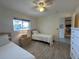 Bedroom featuring twin beds, ceiling fan, and a view to the outside at 6800 Placida Rd # 272, Englewood, FL 34224