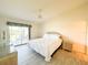 Cozy bedroom featuring a queen bed, ceiling fan, and sliding glass doors to the patio at 6800 Placida Rd # 272, Englewood, FL 34224