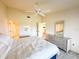 Comfortable bedroom with a ceiling fan, dresser, and access to the ensuite bathroom at 6800 Placida Rd # 272, Englewood, FL 34224